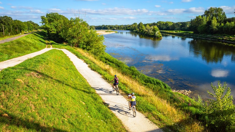 Bikers along river path