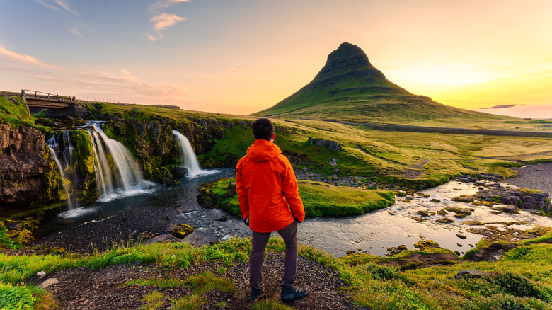 A person stands overlooking an Icelandic landscape