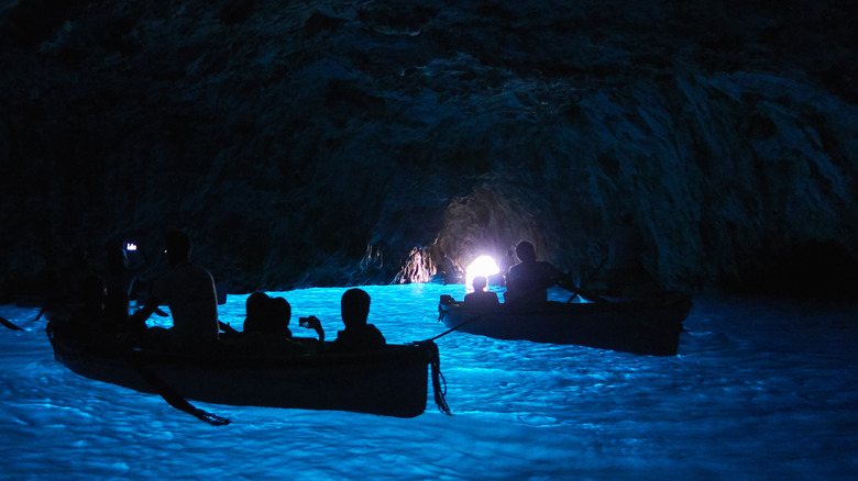 row boats inside blue grotto in Italy