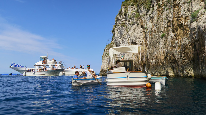 tour boats outside blue grotto in Italy