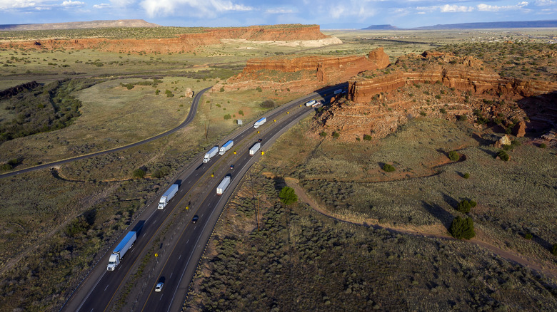 Highway between red rocks in New Mexico, US