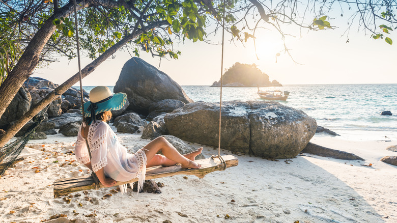 Woman on a beach swing