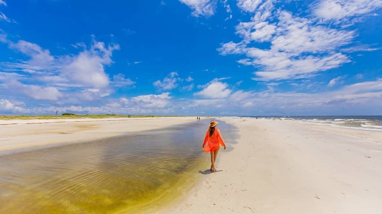 Woman walking on Ship Island beach