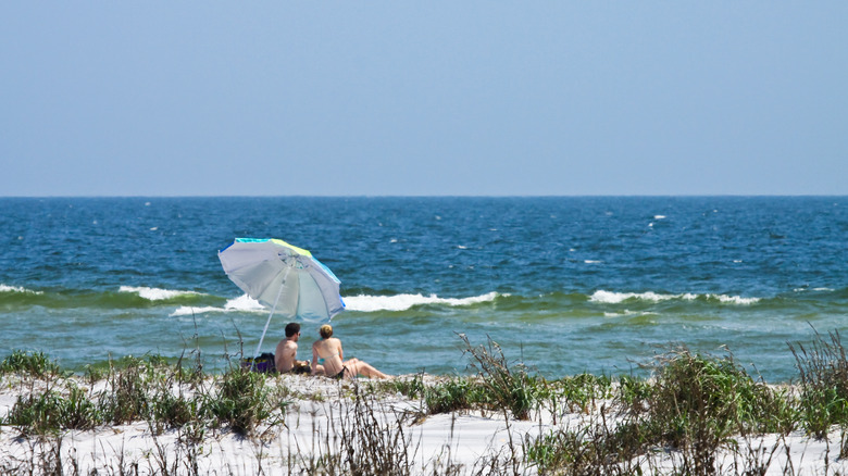 Couple sitting on Ship Island beach