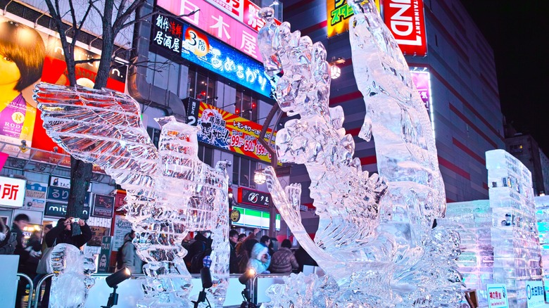 Ice sculptures on a neon lit street