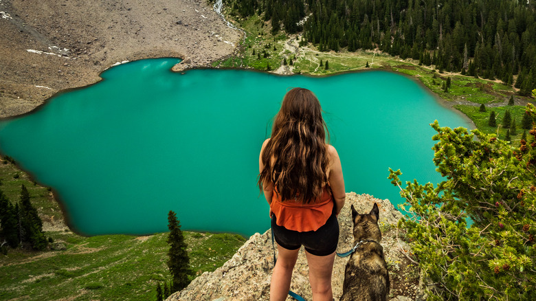 Girl and dog hiking to Telluride alpine lake