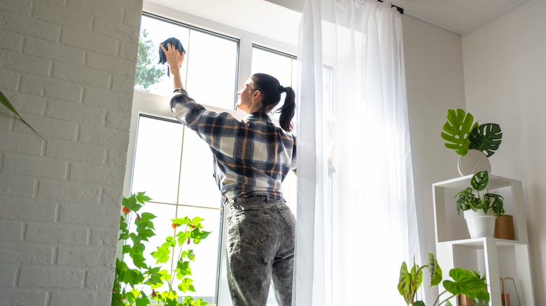 A woman cleaning a window