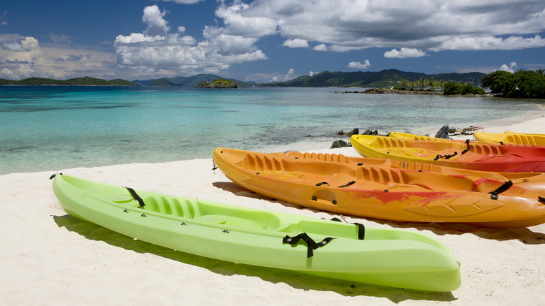 three colorful canoes on beach