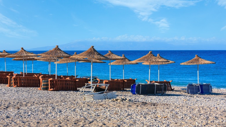 empty beach chairs on sand