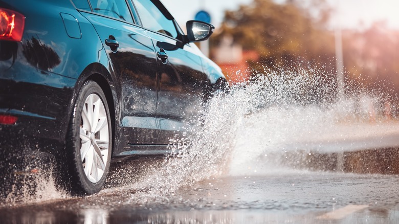 car splash puddle through rain