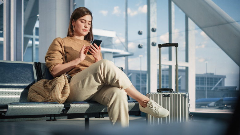 woman at airport with phone