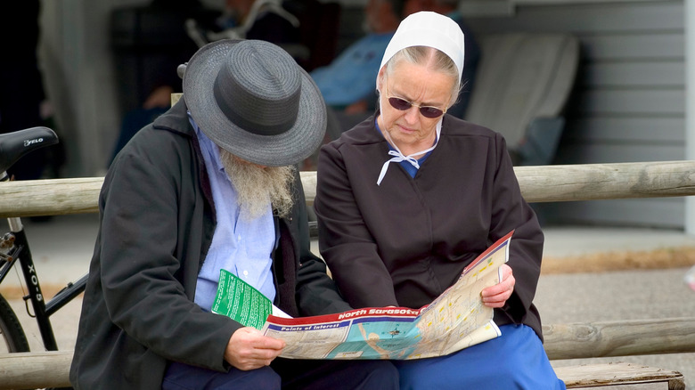 An older Amish couple reading a map of Pinecraft in Sarasota, Florida