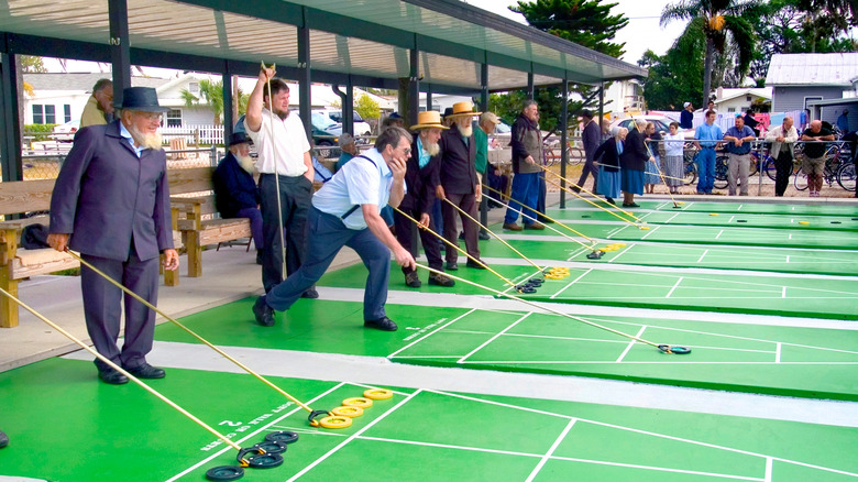 Amish men enjoy playing shuffleboard in Pinecraft in Sarasota, Florida