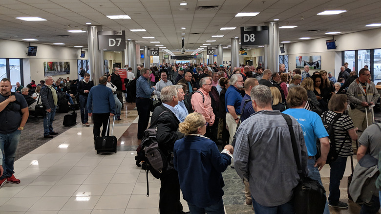 Passengers waiting at busy airport (ATL)