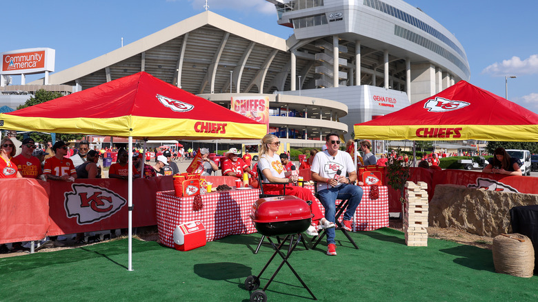 Two people hosting an American tailgate