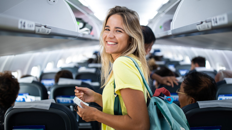 Smiling woman on airplane