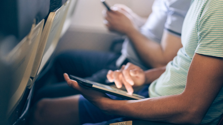 People wearing cotton shirts on an airplane