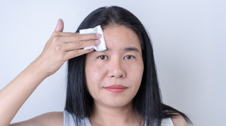 A woman wiping her hair