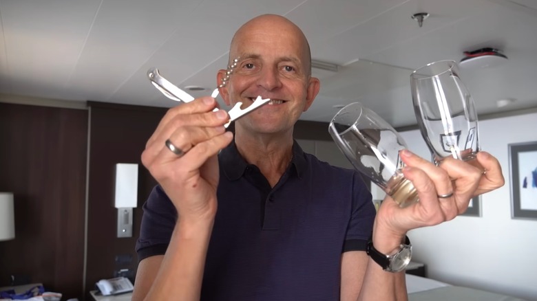 A man holding two wine glasses and a wine key