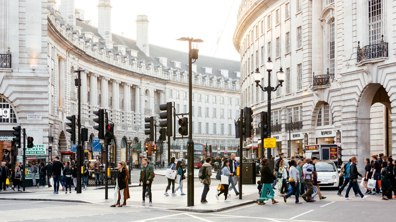 Crowds walking through Piccadilly Circus junction in London