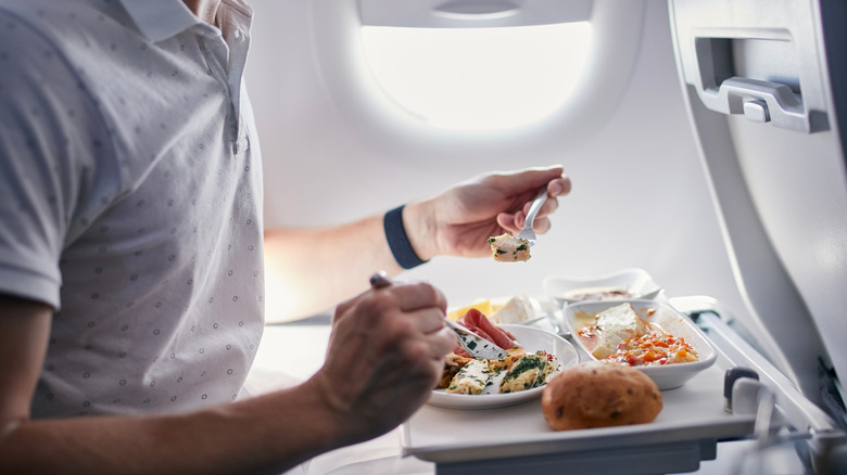 Man eating airplane food 