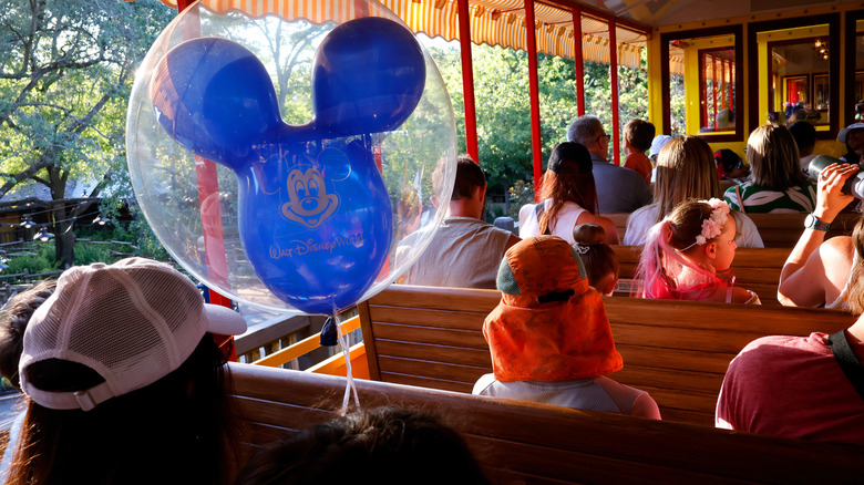 People sitting on a train at Walt Disney World