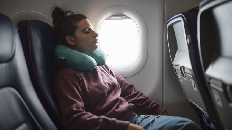 woman sleeping on plane