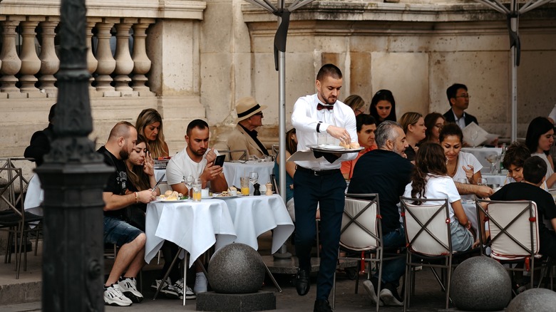 Waiter at busy French cafe