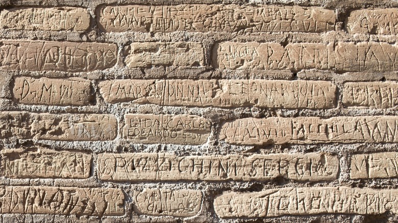 Wall of Colosseum with names scratched in