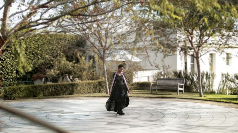 Lone woman walking along a labyrinth