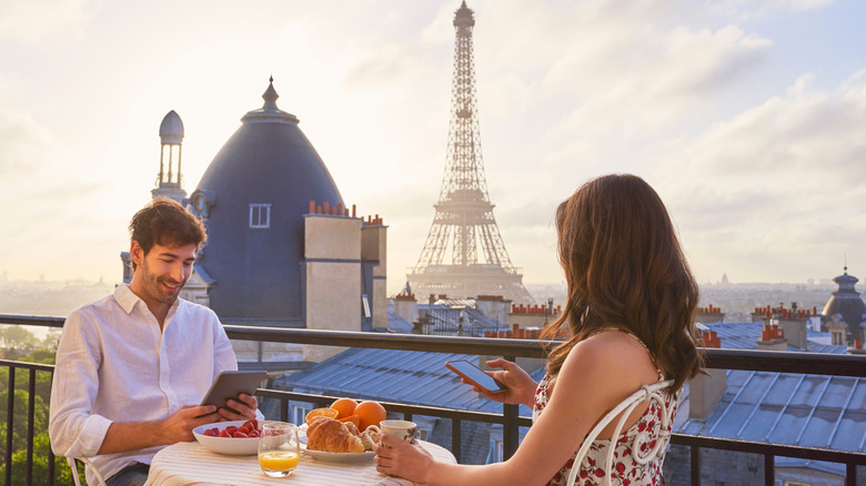 Couple eating with a view of the Eiffel Tower in Paris