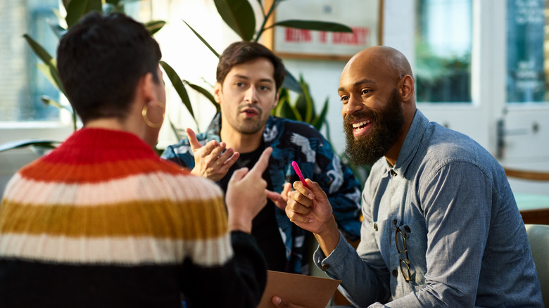 Three people talking