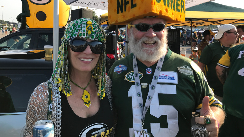 Two packers fans dressed in jerseys