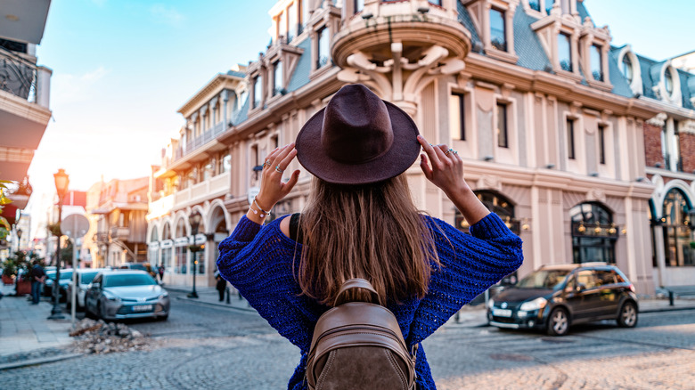 Girl wearing hat exploring the city