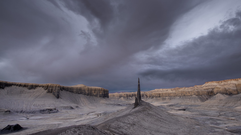 Sandstone spire under stormy desert sky