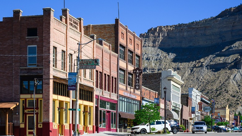 Buildings in downtown Helper, Utah, beside a rocky mountain