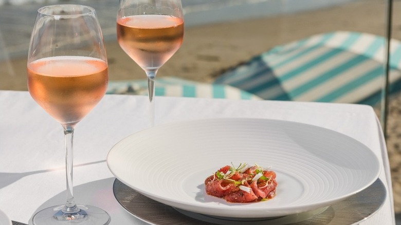 Oceanside table with dinner and wine at Caruso's in Montecito