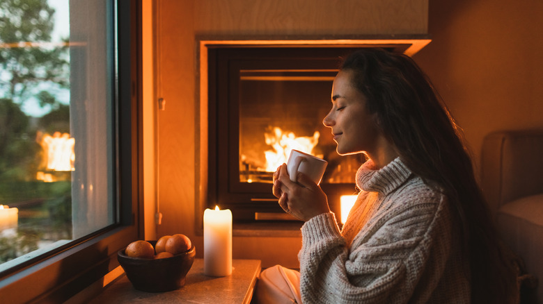 Woman practicing Danish hygge at hotel