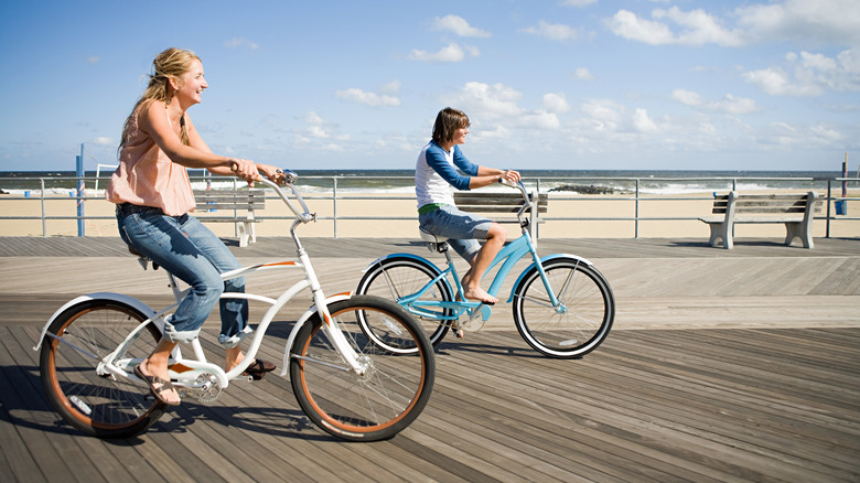 Two people biking on boardwalk