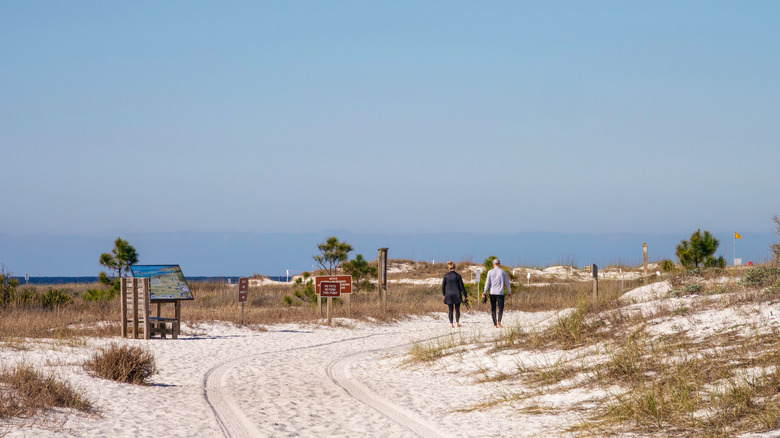 Couple walking on beach path