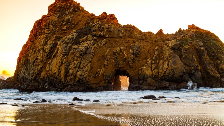 The sun setting behind Pfeiffer Beach Keyhole Rock