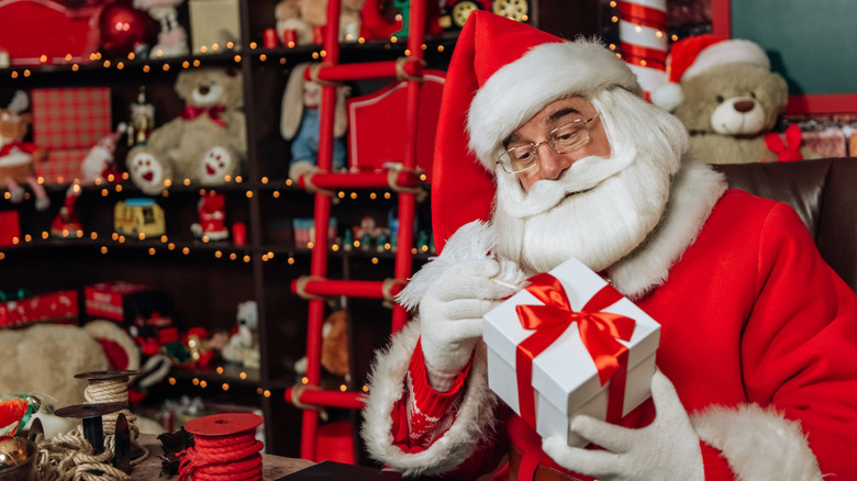 Santa Claus preparing a gift