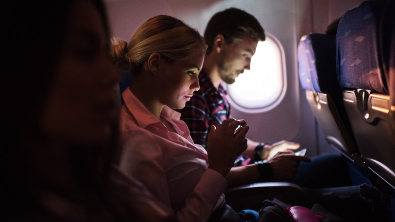 Passengers using her phone mid-flight
