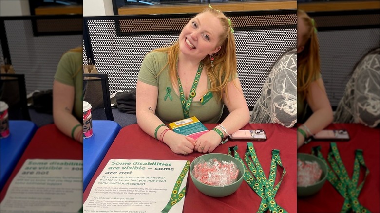 A Pace University student promoting sunflower lanyards