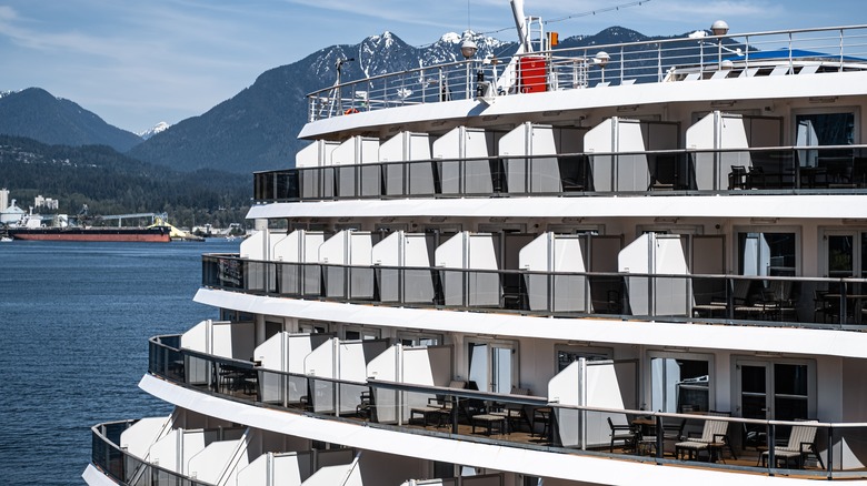 cruise ship sailing in front of mountains