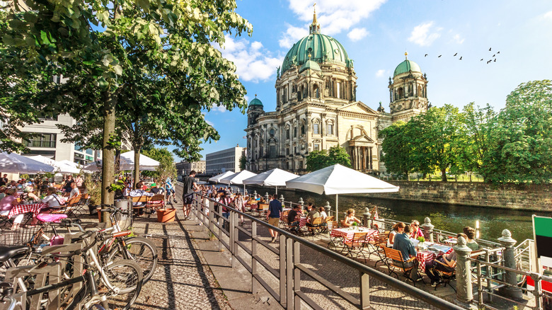 People eating at a river terrace in Berlin, Germany