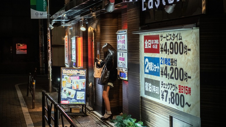 Woman waits outside love hotel in Japan