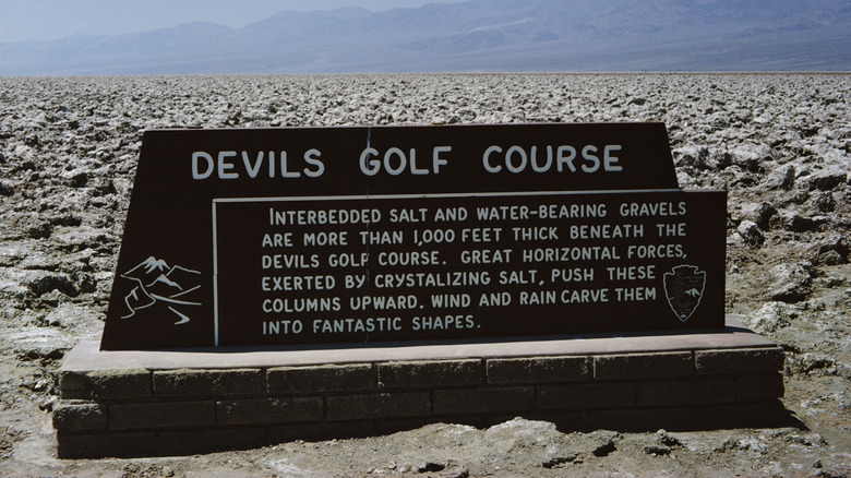 jagged terrain and sign at the Devil's Golf Course in Death Valley, California