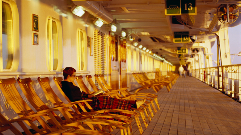 Person sitting in deck chair on cruise