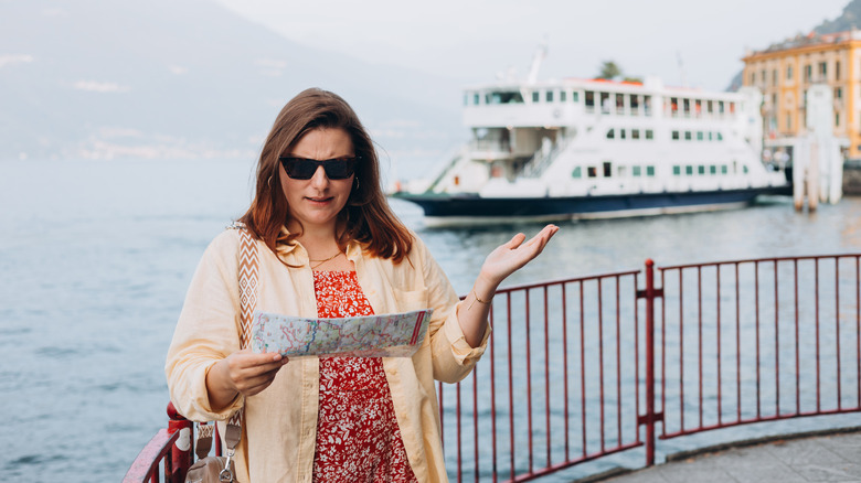 A stressed traveler standing by a cruise port